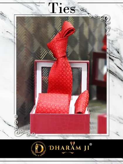 A vibrant red textured tie and pocket square set. An accessory like this can add a bold pop of color to a classic suit.