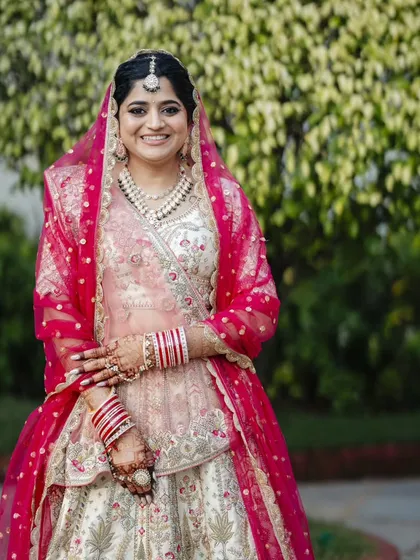 A series showcasing a beautiful sunset wedding look. The bride's makeup is soft and romantic, with a flawless base and defined eyes, perfectly complementing her stunning pastel lehenga for a picturesque Goa wedding.