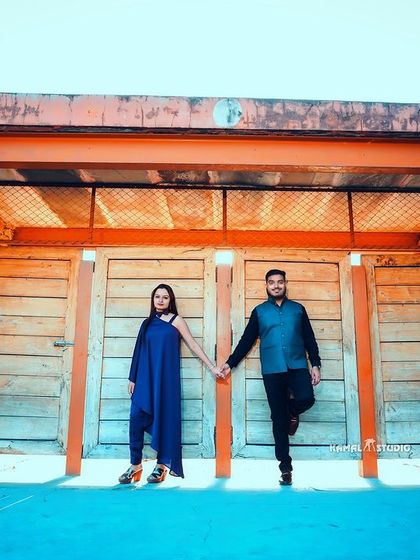 A modern, edgy pose against a rustic gate, showing how we can find unique and contemporary frames even in traditional locations.