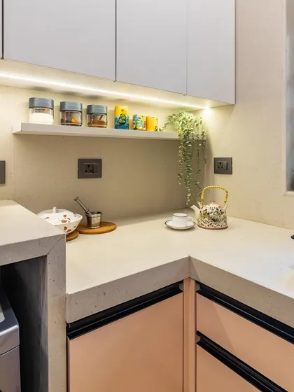 A small floating shelf provides the perfect spot for frequently used spices and mugs, keeping the countertop clear and organized.