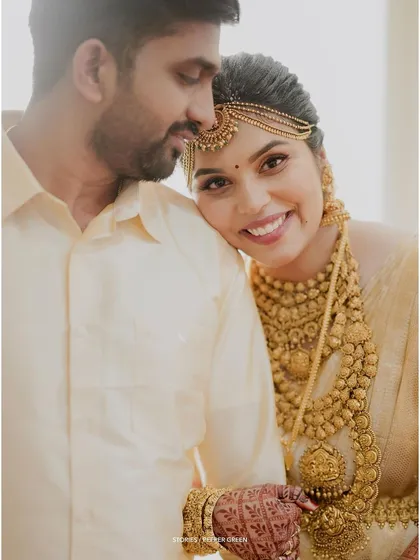 A beautiful, serene portrait of the bride resting her head on the groom's shoulder, her eyes content.
