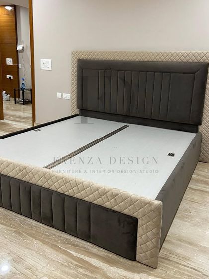 This custom bed features a dual-textured headboard, combining a smooth dark grey central panel with a quilted beige outer frame. The design is modern, unique, and tailored to our client's taste.