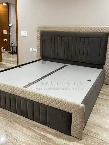 A custom bed with a two-tone, quilted design. The combination of dark and light fabrics on the headboard and frame adds visual interest and a bespoke touch to this bedroom set.