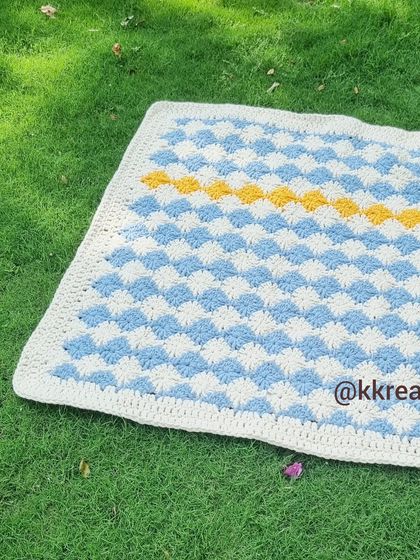 This blanket is made using a special stitch that creates a woven, checkerboard effect. It's a beautiful and timeless pattern.