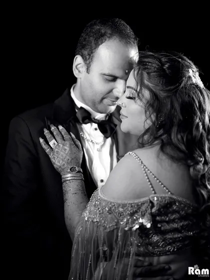 A classic black and white portrait that captures the deep emotion and connection between the couple. The dark background and soft lighting create a timeless and intimate feel.