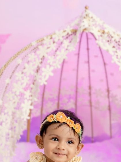 A close-up shot that captures the sweet expression of the baby in the butterfly-themed setup.