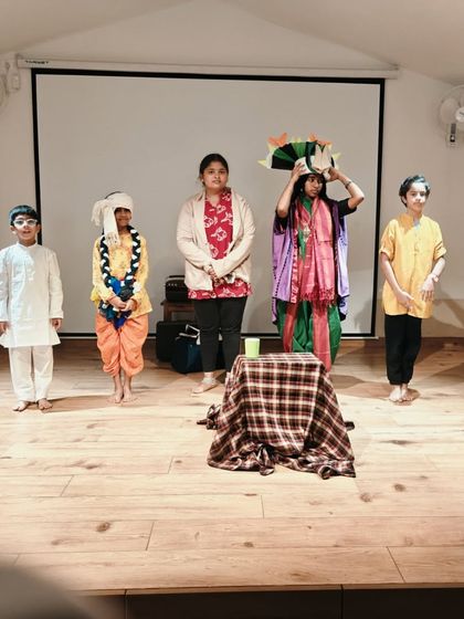 The cast of a children's play during a rehearsal. Even without full costumes or lighting, their focus and character work is evident. This is where the real learning happens.