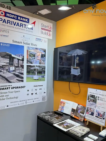 Our exhibition booth at Startup Mahakumbh, featuring a poster of our Smart Solar Huts and a screen displaying our product in action. The booth attracted significant interest from attendees.
