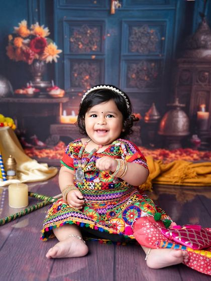 A smile that shines brighter than the festival lights. This little girl's happy expression makes this traditional-themed shoot absolutely perfect.