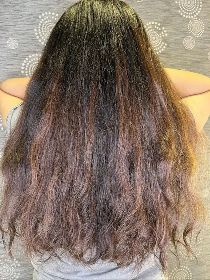 The "before" shot of long hair, ready for a wine red balayage transformation.