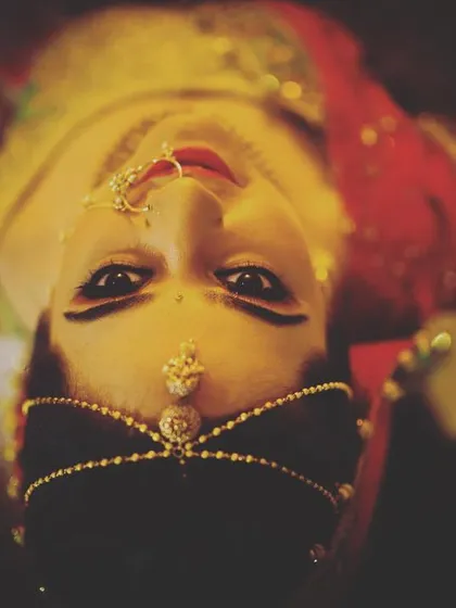 I love experimenting with unconventional angles to create dramatic portraits. This top-down shot of a bride, using a 35mm art lens, draws attention to her eyes and the beautiful symmetry of her maang tikka and nose ring.