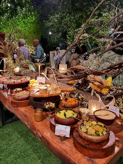 I believe food should be a sensory journey. This rustic grazing table, laden with artisanal cheeses, fresh produce, and gourmet bites, is an example of the bespoke culinary experiences I create.