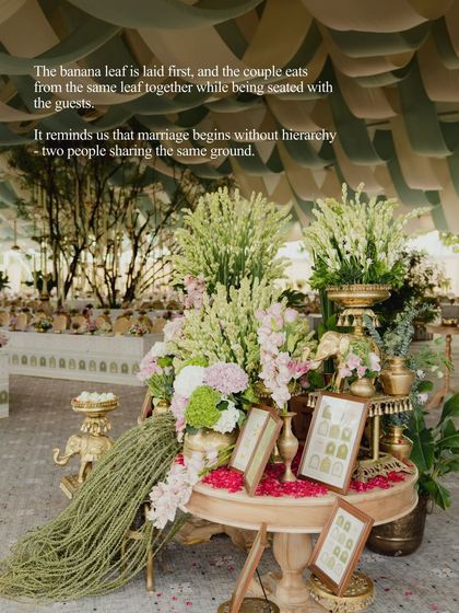 The tradition of the couple eating from the same banana leaf reminds us that marriage begins without hierarchy. We highlighted this beautiful sentiment with a stunning floral centerpiece, blending tradition with bespoke design.