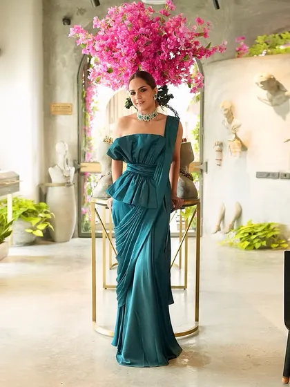 For a cocktail look, we styled this stunning emerald one-piece formal outfit from Ridhi Mehra, elevated with a statement emerald choker from Purab Paschim.