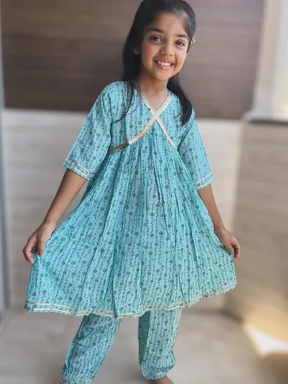 I believe traditional wear should be full of grace, not restrictions. This light and airy blue Angarkha set is made from pure cotton, allowing for endless twirls and happy giggles. The delicate gold detailing adds just the right amount of festive sparkle.