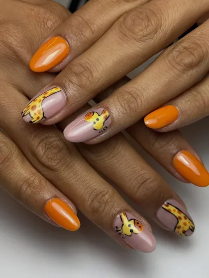 How cute is this? I created this playful giraffe design for a client who wanted something fun and wild. The combination of detailed animal art with bold, solid orange nails really makes it pop.