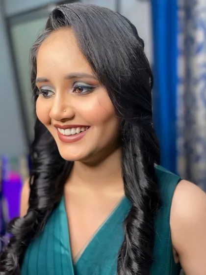 Another angle of this party-ready look. The soft curls frame her face beautifully, and the makeup enhances her natural features.