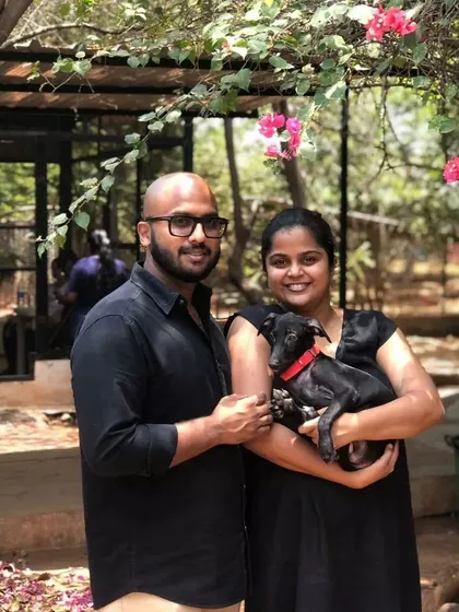 A smiling couple proudly holds their new family member, a small black puppy adopted from our event in Coimbatore. Every adoption makes space in the shelter for another animal in need.