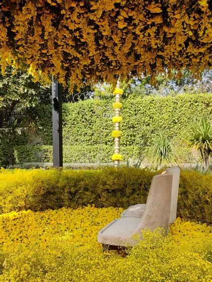 A side view of the Haldi seating area, showing how the space was completely transformed with thousands of yellow flowers.