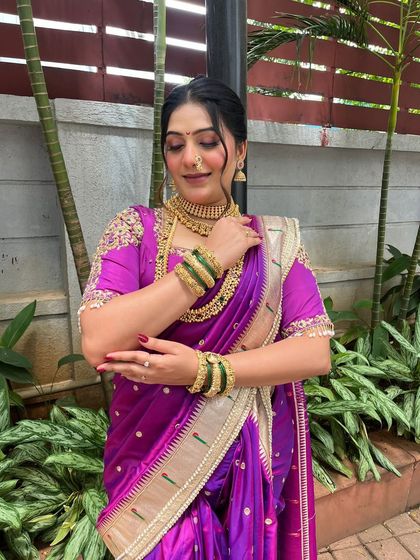 A stunning portrait of a client in a purple Paithani saree. I styled her hair in a classic updo to complete this traditional and regal look.