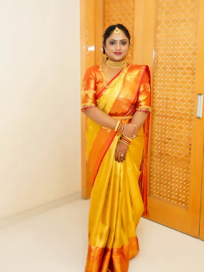 A full-length shot showing the timeless beauty of a silk saree. The makeup is kept classic and elegant to match the traditional attire.