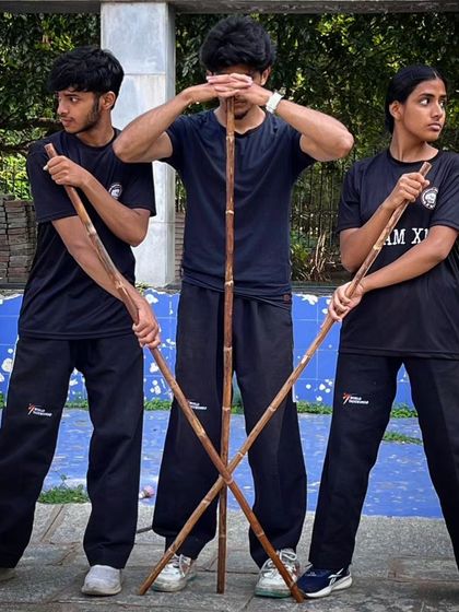 Three of my students in a powerful pose with their Bo Staffs, ready for training.