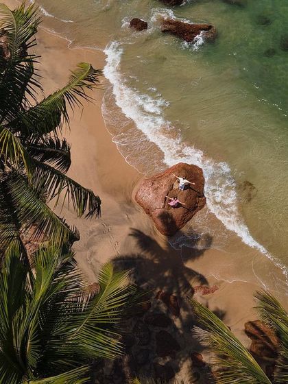 Another angle of the couple on the rock, this drone shot offers a slightly different framing with the palm trees. It shows how we can get a variety of epic shots from one location.
