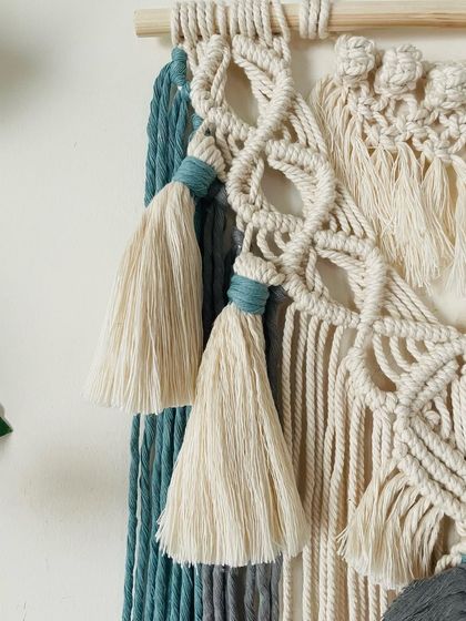 A close-up of the tassels and the diamond-patterned knots on the 'Bella' tapestry. I use a pop of teal to tie the tassels, which adds a nice little detail.