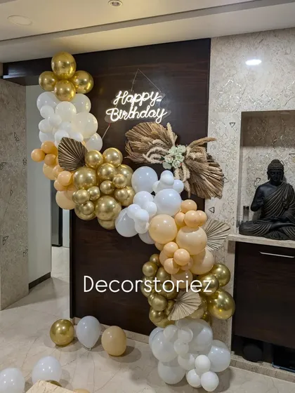 A wider view of the trendy boho-themed birthday decoration, showing how the balloon garland elegantly frames the wall space.