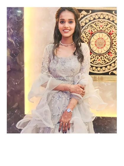 Our client looks lovely in this grey gown-style lehenga with delicate ruffles. It's a modern and elegant choice for a reception or cocktail party.