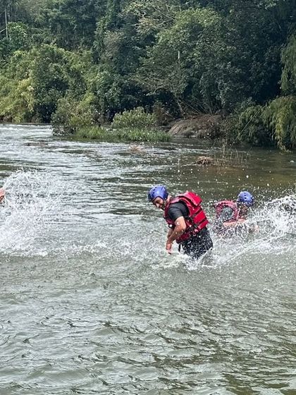 Participants enjoying a splash fight in the calm sections of the Barapole river in Coorg. Our camps balance high-adrenaline activities with moments of pure fun.