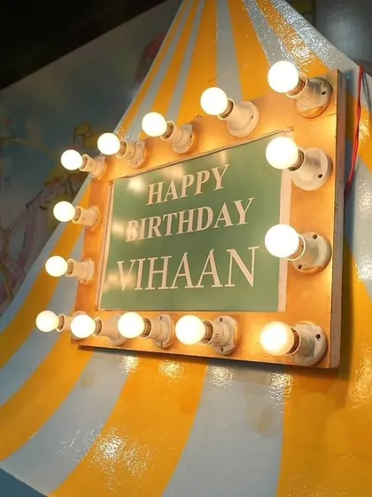 The lighted birthday sign on the circus tent prop. It's these details that make the celebration feel personal and special.
