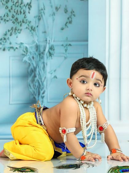 This crawling little Krishna is simply divine. The simple, clean background keeps all the focus on his innocent and charming expression.