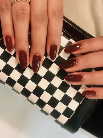 A classic glossy maroon manicure. This rich color is timeless and always looks elegant.