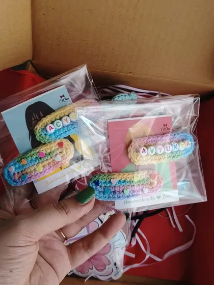 Holding a couple of freshly packed name clip sets for 'Acy' and 'Aadya'. They make such a great, affordable, and personal gift.