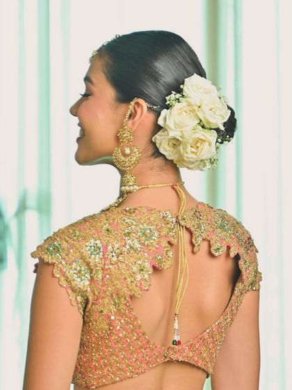 A classic rose bun is always a winning choice for a bride. I used fresh white roses to create this elegant and timeless updo, perfect for a traditional wedding ceremony.