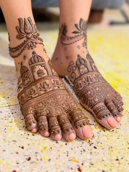 A clear, straight-on shot of the beautiful architectural foot mehendi.