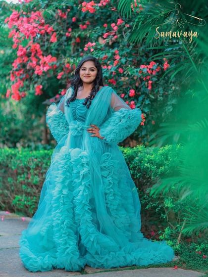 This beautiful turquoise frill gown stands out against the pink bougainvillea. My outdoor locations are chosen to complement the outfits you select.
