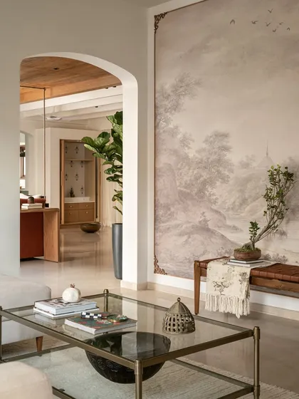 Arches and murals are two of our favorite design elements for adding character. In the Earthy Hacienda's formal living room, a soft arch leads the eye towards a custom framed mural, creating a calm, modern, and layered presence that draws you in.