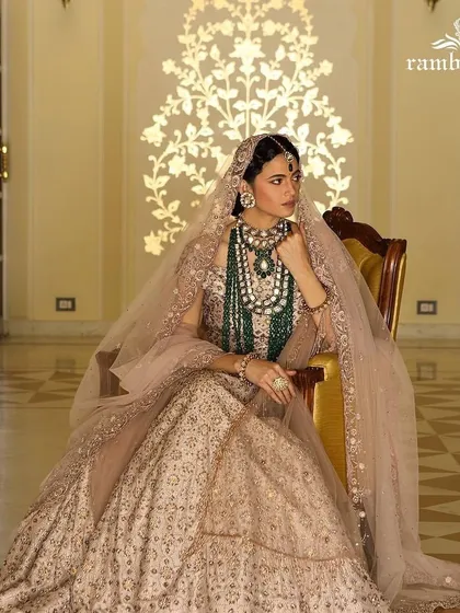 A showcase of classic bridal styling. For this shoot, I created a regal and timeless look, layering a heavily embroidered lehenga with exquisite emerald Polki jewelry and a delicate veil to craft a portrait of bridal opulence.