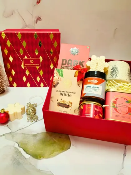 The Christmas Extravaganza Gift Box, featuring a festive mug, coffee cookies, and almond brownie brittle, all packed in a luxurious red box.
