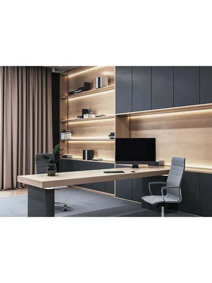 We design home offices that inspire productivity. This workspace integrates a large desk with extensive, back-lit wooden shelving and dark, minimalist cabinets, creating a professional and organized environment that is perfectly blended into the home's aesthetic.