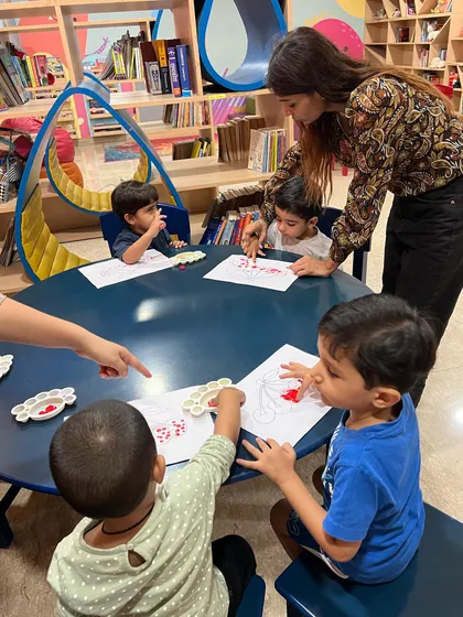 Look at these little artists so focused on their creations. In our arts and crafts sessions, I guide them through activities like finger painting, which helps improve their fine motor skills and express their creativity.