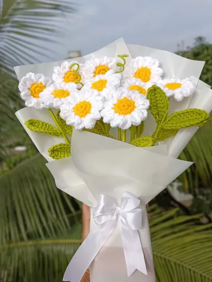 A classic bouquet of white daisies, elegantly wrapped.