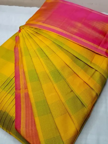 A yellow and pink checked cotton-silk saree.