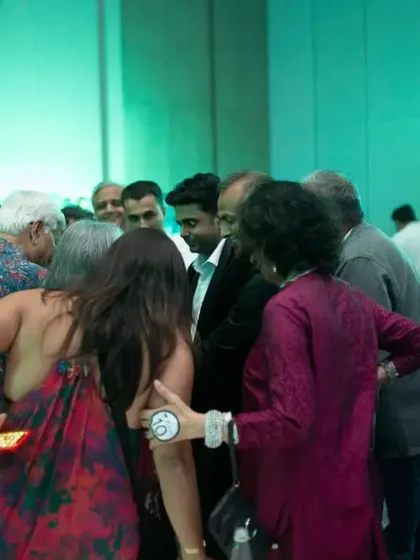 A group of guests huddle together, completely absorbed in the close-up magic happening in front of them. It's all about creating an intimate and captivating experience.