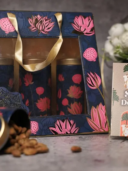 A beautiful gift bag with matching dry fruit tins inside. This is a great example of creating a complete, branded gifting suite.