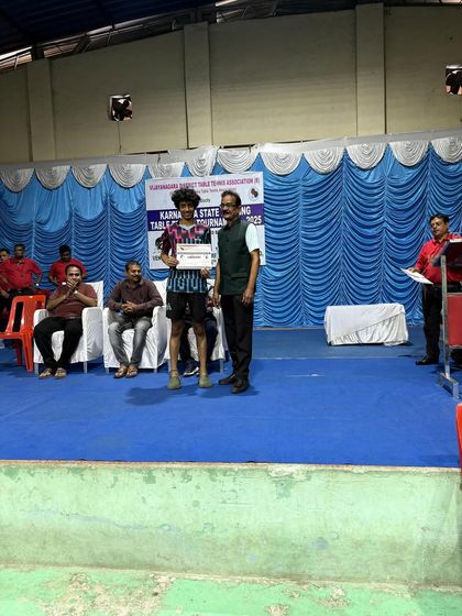 Abhinav K Murthy on the podium after securing 3rd place in the Men's Singles at the Hospet state ranking tournament.