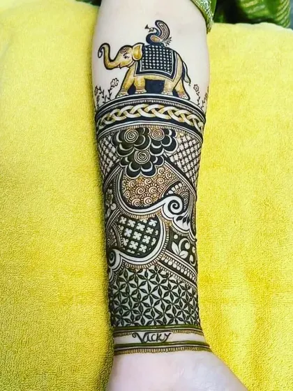 The elephant armband design expanded to cover the full forearm with intricate patterns.