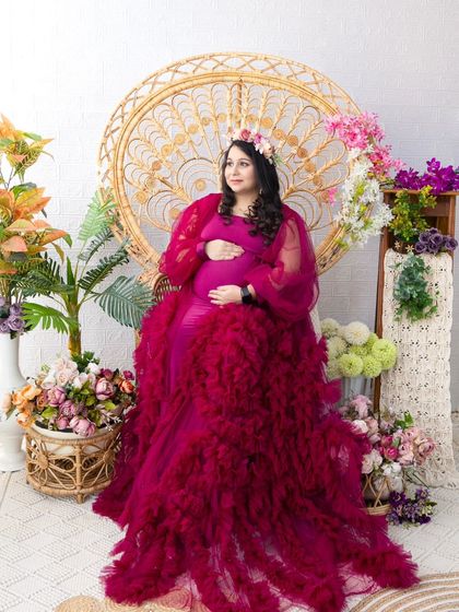 This magnificent magenta gown is all about drama and luxury. The rich color and cascading ruffles create an unforgettable look for a truly show-stopping maternity portrait.
